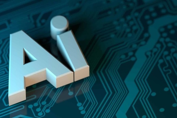 3D letters "AI" for artificial intelligence sit atop a dark teal circuit board.  The letters are metallic silver and appear to hover just above the surface, casting a small reflection.